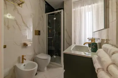 a bathroom with a toilet and a sink and a shower at YCH-Ponte Lungo apartment in Rome