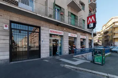 a building on a city street with a store at YCH-Ponte Lungo apartment in Rome