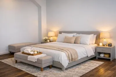 a bedroom with a large bed with two tables and a chair at Vatican Pertusa Luxury Suites by Quinto Piano in Rome