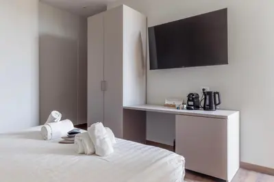 a hotel room with a bed with towels on it at Vatican Pertusa Luxury Suites by Quinto Piano in Rome