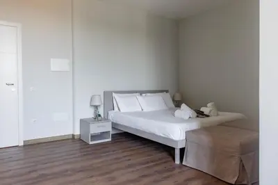 a bedroom with a large white bed with white pillows at Vatican Pertusa Luxury Suites by Quinto Piano in Rome
