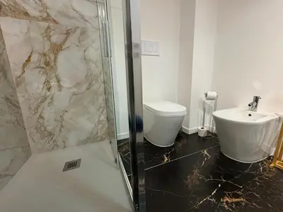a bathroom with a shower and a toilet and a sink at Residenza Piramide in Rome