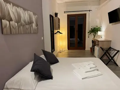 a bedroom with a white bed with towels on it at Residenza Piramide in Rome