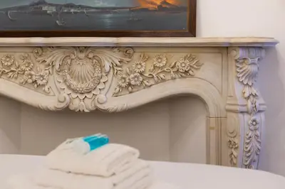 a pile of towels sitting on top of a mirror at iFlat A Vintage Gem Apartment near Piazza Navona in Rome