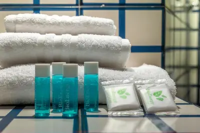 a pile of towels and toiletries on a table at iFlat A Vintage Gem Apartment near Piazza Navona in Rome