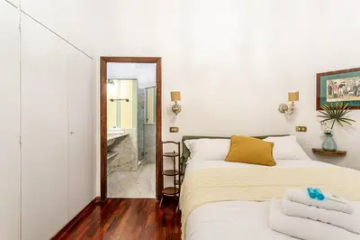 a bedroom with two beds and a mirror at iFlat A Vintage Gem Apartment near Piazza Navona in Rome
