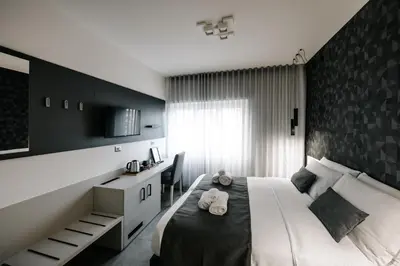 a bedroom with a large bed with a black wall at B&B Lumas Up in Rome