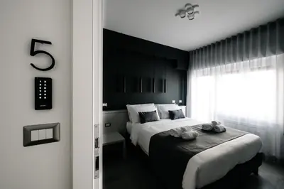 a black and white bedroom with a bed and a window at B&B Lumas Up in Rome