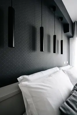 a bedroom with a white bed with black pendant lights at B&B Lumas Up in Rome