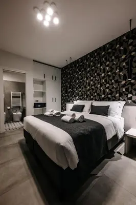a bedroom with a large bed with a wooden wall at B&B Lumas Up in Rome