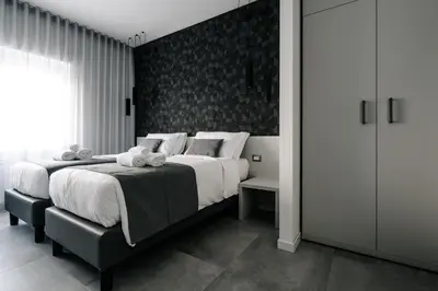 a bedroom with a large bed with white sheets at B&B Lumas Up in Rome
