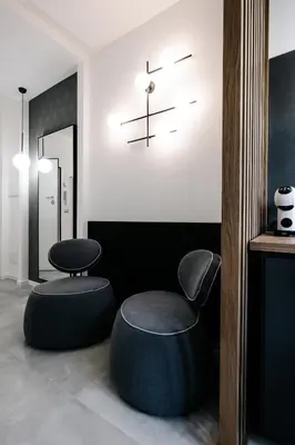 a room with two chairs and a clock on the wall at B&B Lumas Up in Rome