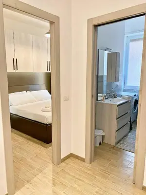 a bedroom with a bed and a sink and a mirror at a pochi passi dalla Metro A e dal Vaticano - NUMA HOUSE in Rome