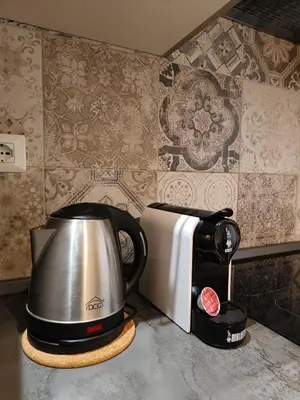 a tea kettle on a stand next to a toaster at a pochi passi dalla Metro A e dal Vaticano - NUMA HOUSE in Rome