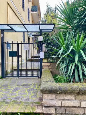 a gate to a building with a fence and plants at a pochi passi dalla Metro A e dal Vaticano - NUMA HOUSE in Rome