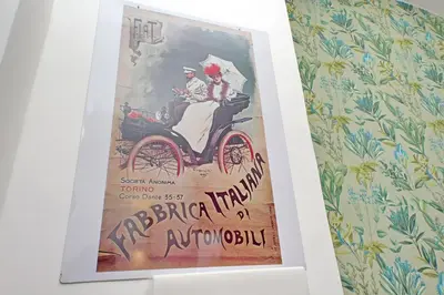 a poster of two men riding in a carriage at Vatican 47 in Rome