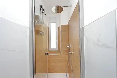a bathroom with a shower with a glass door at Vatican 47 in Rome