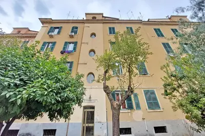 a yellow building with trees in front of it at Vatican 47 in Rome