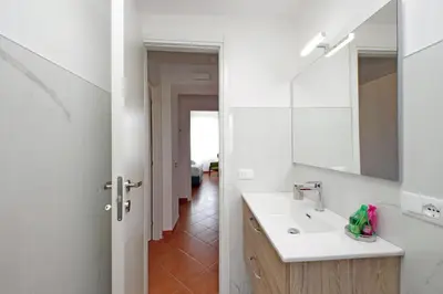 a white bathroom with a sink and a mirror at Vatican 47 in Rome