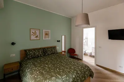 a bedroom with a bed and a flat screen tv at Il balconcino di Emma in Rome