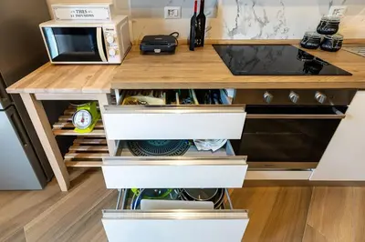 a kitchen with a counter with white drawers at Il balconcino di Emma in Rome