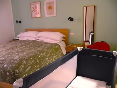 a bedroom with a bed with pillows and a mirror at Il balconcino di Emma in Rome