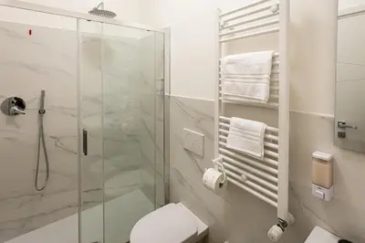 a bathroom with a glass shower and a toilet at Il balconcino di Emma in Rome