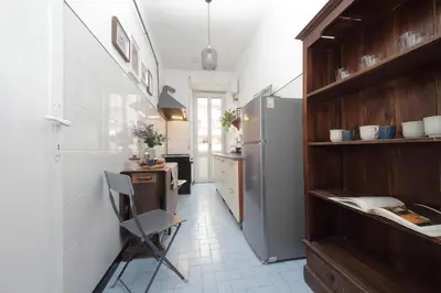 a kitchen with a refrigerator and a table at Giuliana Vatican Family Home in Rome