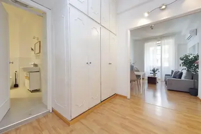 a living room with white cabinets and a couch at Giuliana Vatican Family Home in Rome