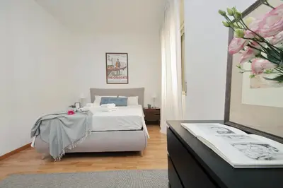 a bedroom with a bed and a dresser with a mirror at Giuliana Vatican Family Home in Rome