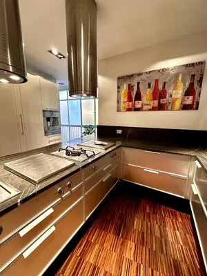 a kitchen with a painting of wine bottles on the wall at Dimora XIX in Rome