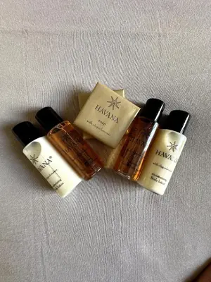 a group of three bottles of soap on a table at Dimora XIX in Rome