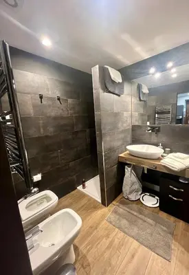 a bathroom with two sinks and a toilet and a shower at Appartamento My Happy Place Rome in Rome