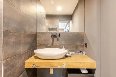 a bathroom with a white sink and a mirror at Appartamento My Happy Place Rome in Rome