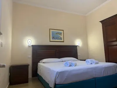 a bedroom with a bed with towels on it at Domi 10 Apartment, Stazione Termini, Via Curtatone 12 in Rome