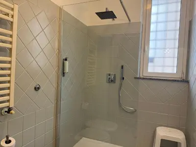 a bathroom with a shower with a toilet and a window at Domi 10 Apartment, Stazione Termini, Via Curtatone 12 in Rome