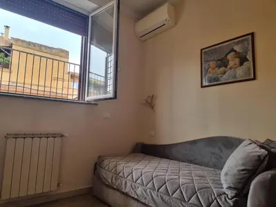 a living room with a couch and a window at Domi 10 Apartment, Stazione Termini, Via Curtatone 12 in Rome