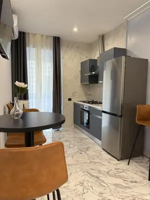 a kitchen with a table and a stainless steel refrigerator at Arte di Roma - Guest House in Rome