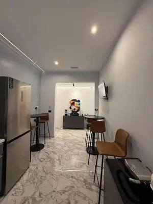 a room with tables and chairs and a refrigerator at Arte di Roma - Guest House in Rome