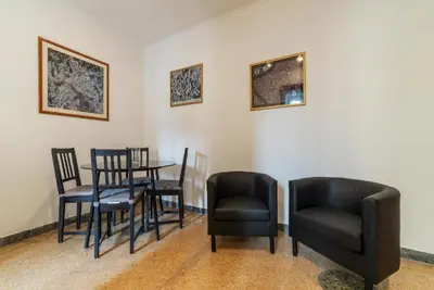 a dining room with black chairs and a table at GuestHost - Piazza Bologna Apartment in Rome