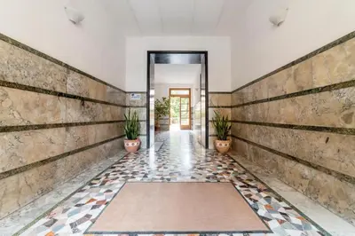 a hallway with potted plants in a building at GuestHost - Piazza Bologna Apartment in Rome