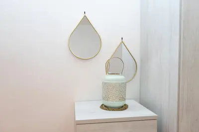a mirror on a shelf with a vase on a table at Minimal e funzionale soggiorno vicino al Vaticano in Rome