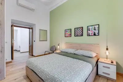 a bedroom with a large bed in a room at 3-Bedroom Home Near Trastevere Station in Rome