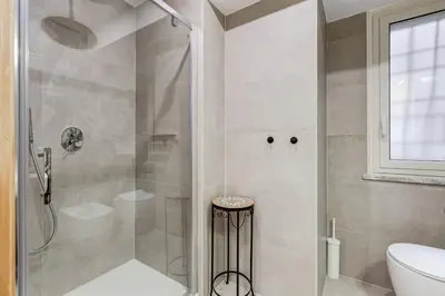 a bathroom with a shower and a toilet at 3-Bedroom Home Near Trastevere Station in Rome
