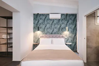 a bedroom with a bed and a wall at Domus Matris Guest House in Rome