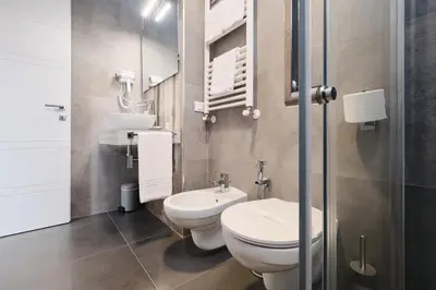 a small bathroom with a toilet and a sink at Domus Matris Guest House in Rome