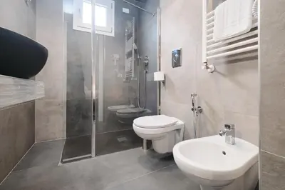 a bathroom with a toilet and a sink and a shower at Domus Matris Guest House in Rome