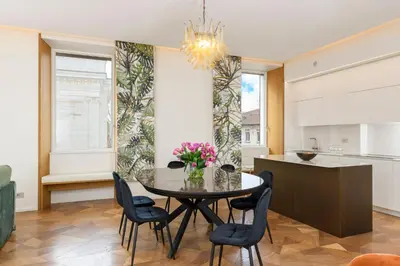 a kitchen and dining room with a table and chairs at Moon River Luxury Apartment in Rome