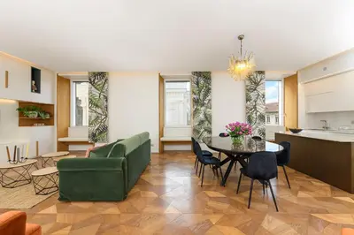a living room with a green couch and a table at Moon River Luxury Apartment in Rome