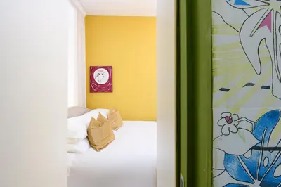 a bedroom with a bed and a clock on the wall at Moon River Luxury Apartment in Rome